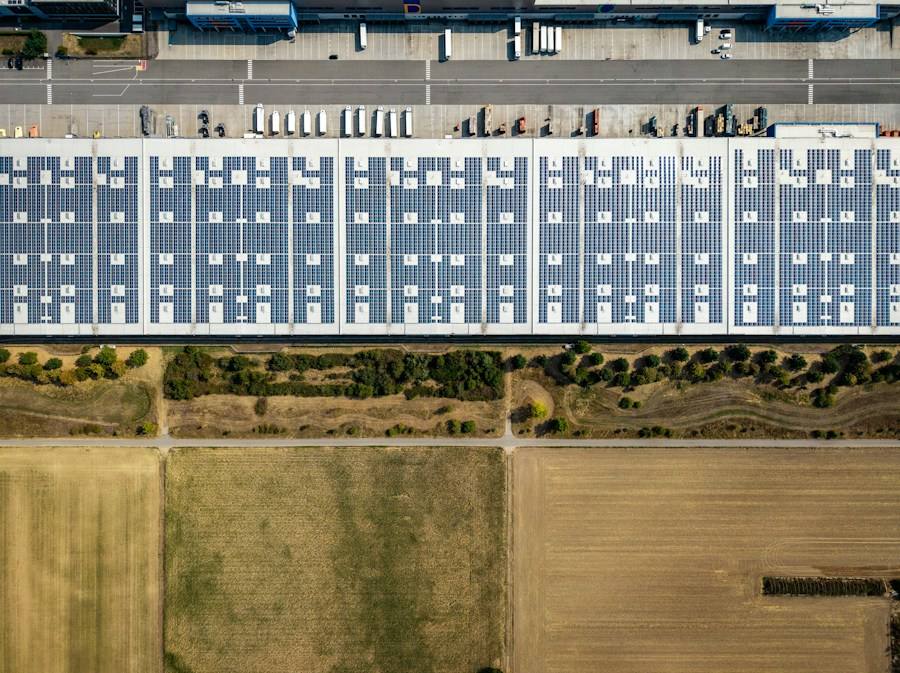 Warehouse roof covered in solar panels, representative image