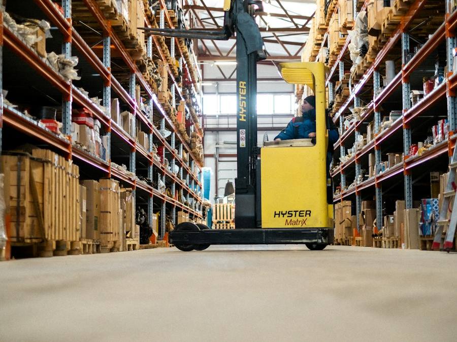 Forklift moving through a large warehouse, representative image