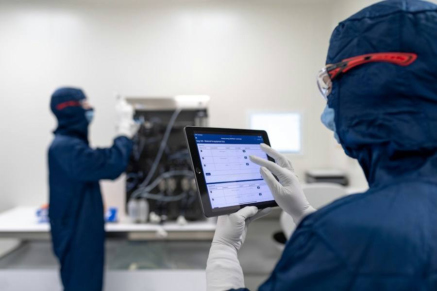 Engineer in a hard hat reviewing a tablet, representative image