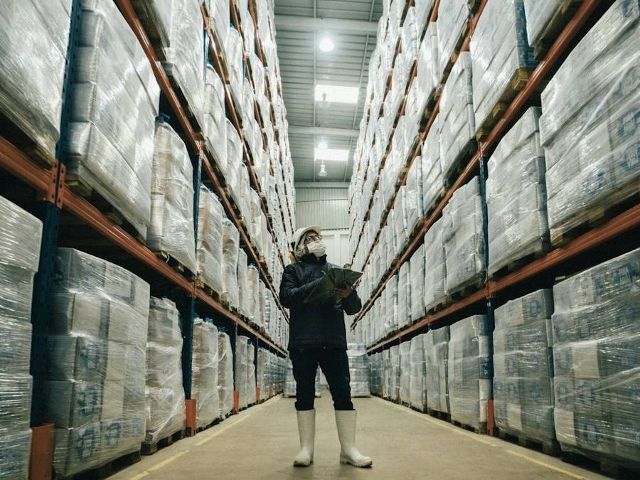 Worker walking through a facility hallway, representative image