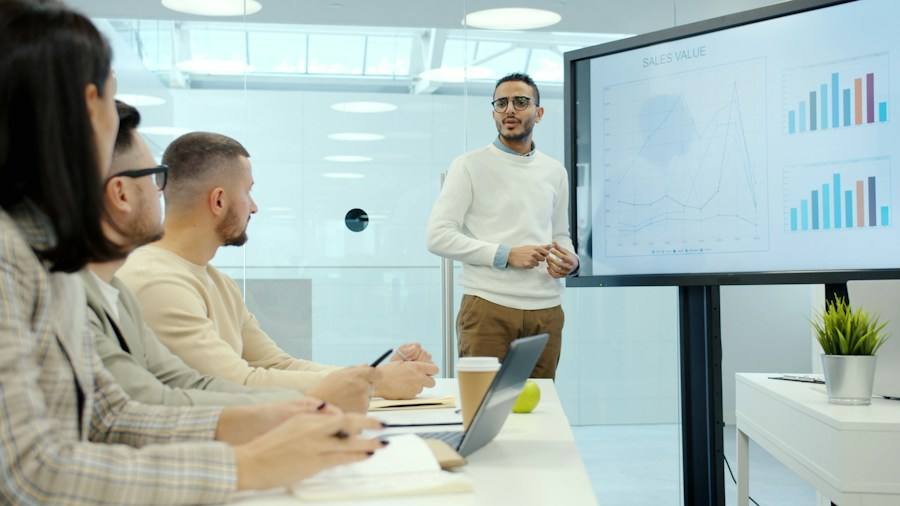 Presenter reviewing charts with colleagues, representative image