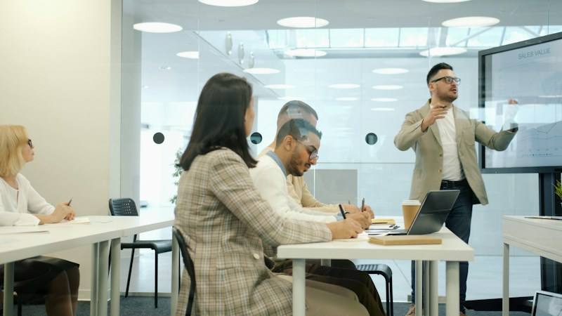 Presenter reviewing slides with colleagues, representative image