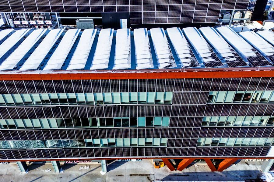 Modern building with solar panels, representative image