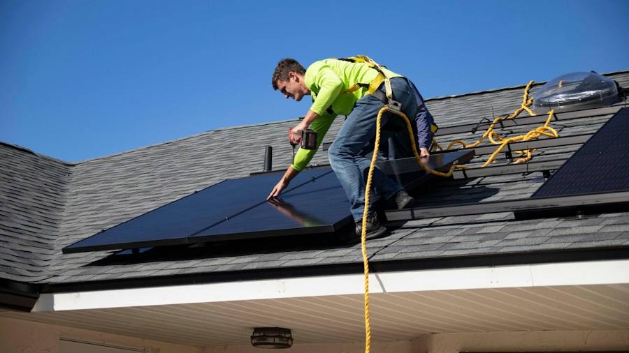 Installer working on a rooftop, representative image