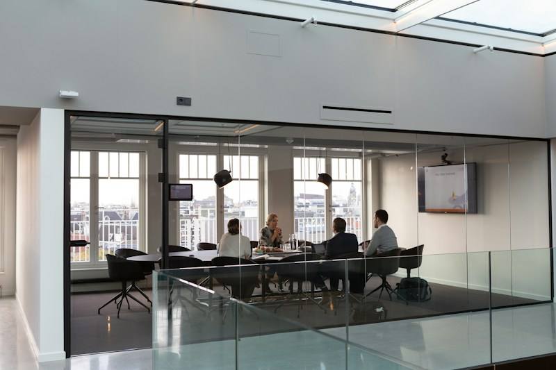 People seated in a building lobby, representative image