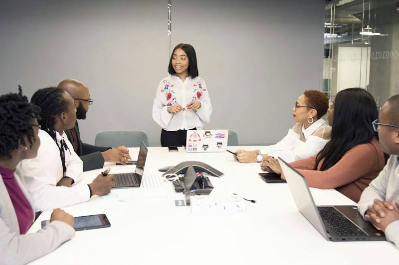 Group working together around laptops, representative image