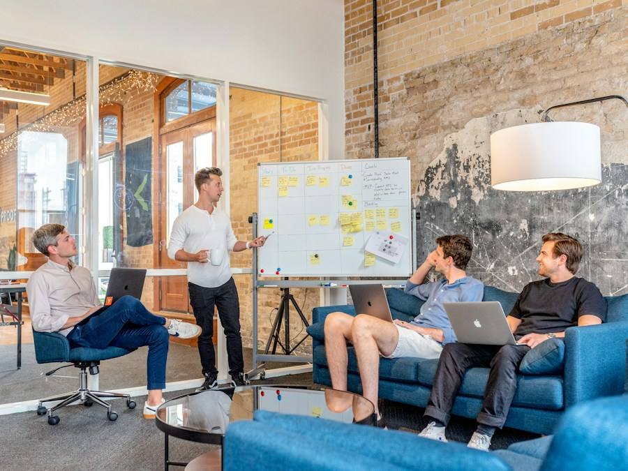 Colleagues reviewing a whiteboard presentation, representative image